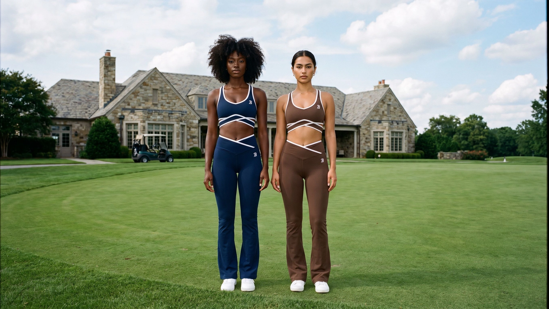Two women pose editorially in Ball Players navy and neutral performance sets at a private golf estate.